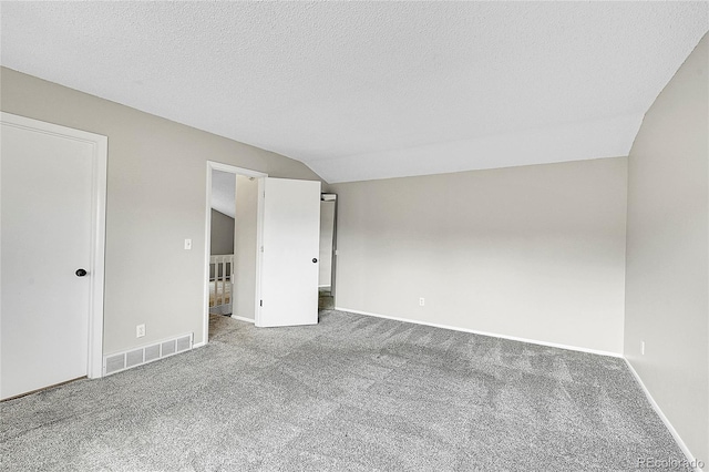 3890 S Atchison Way Unit B, Aurora, CO 80014 - unfurnished room featuring carpet floors, lofted ceiling, and a textured ceiling
