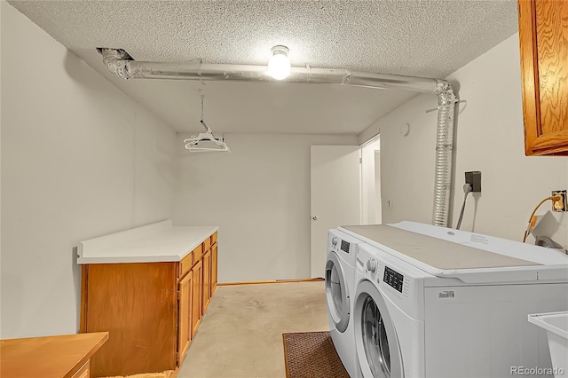3890 S Atchison Way Unit B, Aurora, CO 80014 - washroom featuring cabinet space, washer and dryer, and a textured ceiling