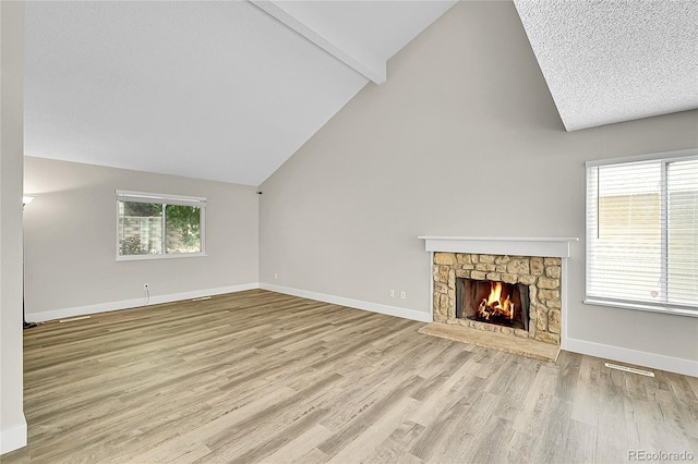 3890 S Atchison Way Unit B, Aurora, CO 80014 - unfurnished living room with wood finished floors and a stone fireplace