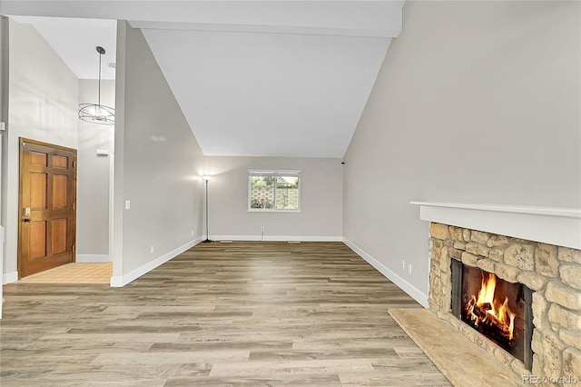 3890 S Atchison Way Unit B, Aurora, CO 80014 - unfurnished living room featuring high vaulted ceiling, wood finished floors, and a fireplace