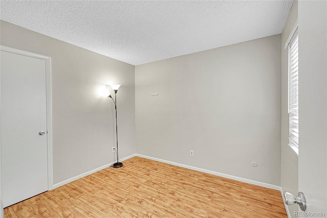 3890 S Atchison Way Unit B, Aurora, CO 80014 - unfurnished room with light wood-style floors and a textured ceiling