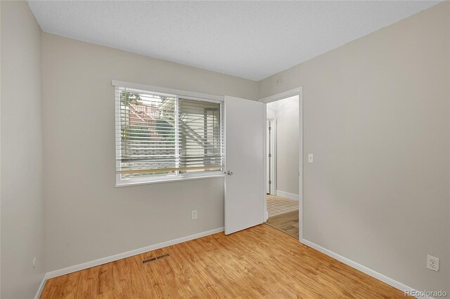 3890 S Atchison Way Unit B, Aurora, CO 80014 - unfurnished room featuring baseboards and wood finished floors