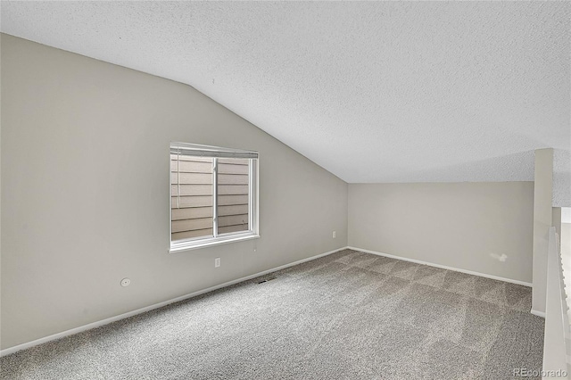 3890 S Atchison Way Unit B, Aurora, CO 80014 - additional living space featuring carpet floors, a textured ceiling, and lofted ceiling