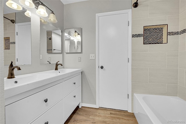 3890 S Atchison Way Unit B, Aurora, CO 80014 - bathroom featuring wood finished floors, double vanity, and bathing tub / shower combination