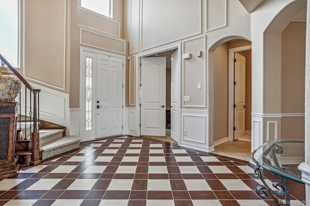 foyer featuring a healthy amount of sunlight and a high ceiling