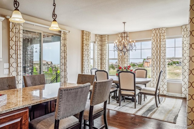 dining space featuring light wood-type flooring and an inviting chandelier