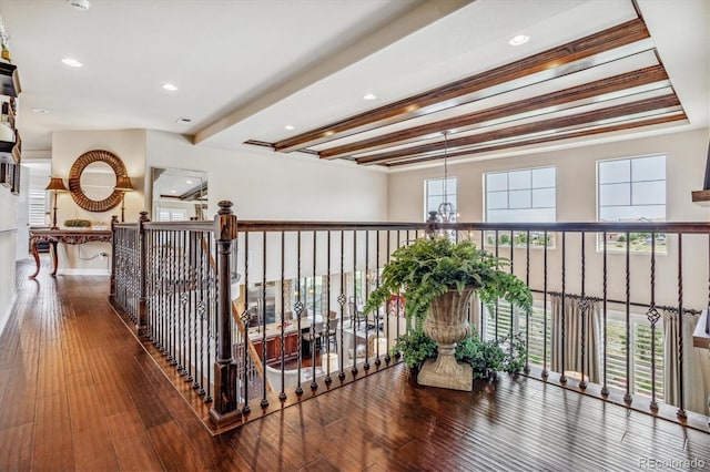 hall with beam ceiling, wood-type flooring, and a notable chandelier