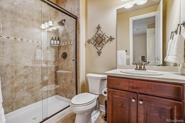 bathroom with walk in shower, vanity, tile patterned floors, and toilet