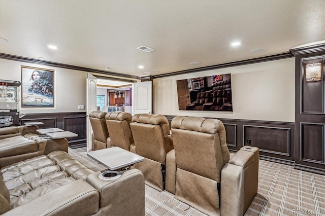 carpeted home theater room featuring ornamental molding