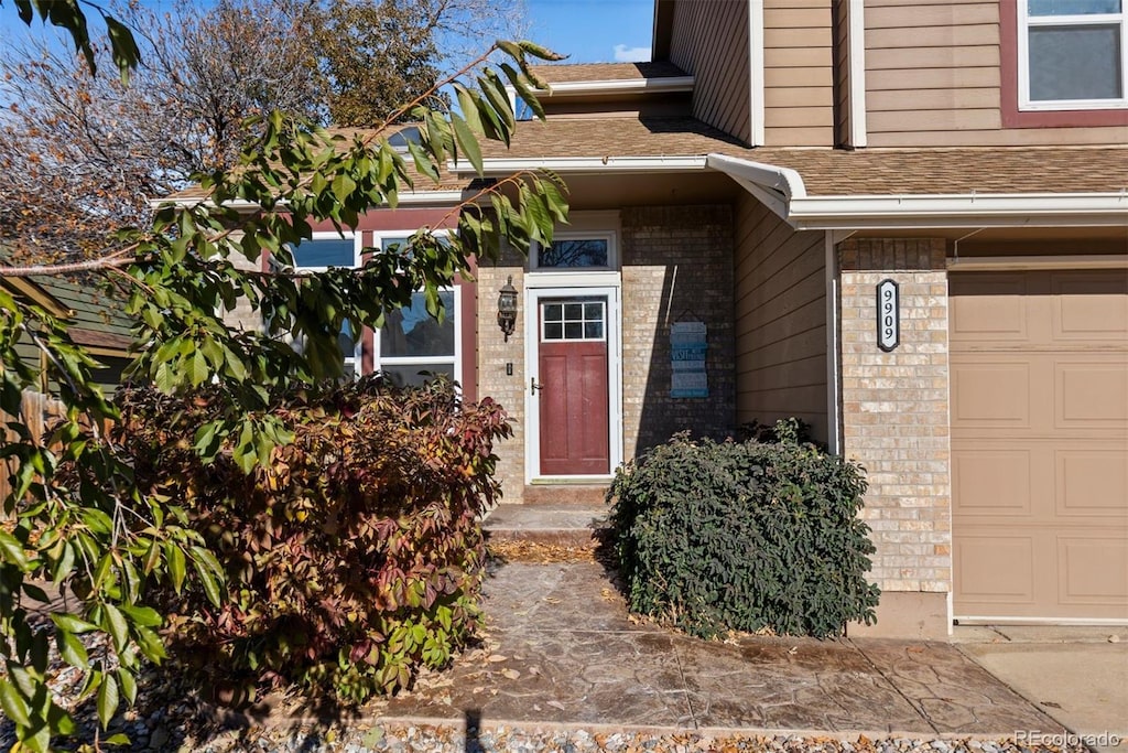 doorway to property with a garage