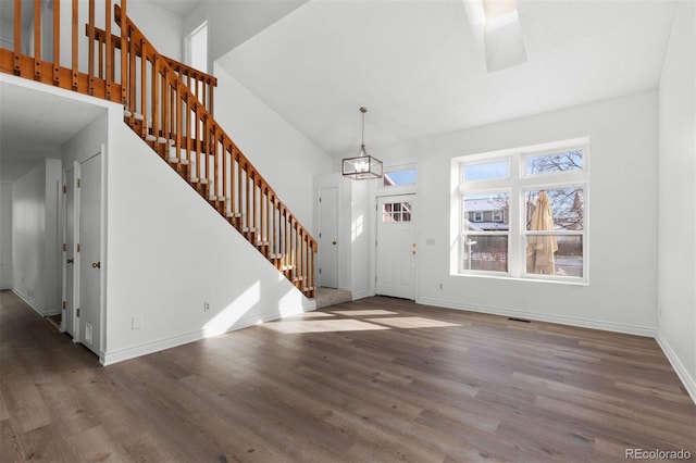 foyer entrance featuring a notable chandelier and wood-type flooring