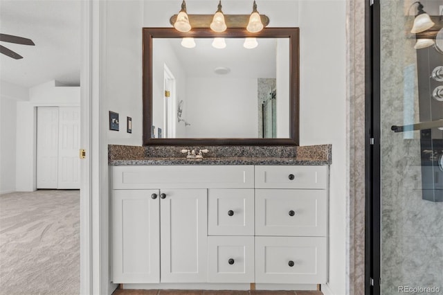 bathroom with vanity, ceiling fan, and walk in shower