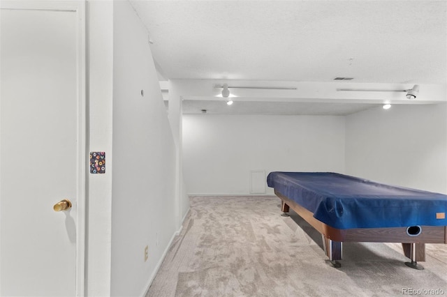 game room featuring a textured ceiling, light colored carpet, and pool table