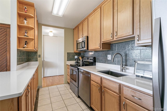 kitchen with light tile patterned flooring, stainless steel appliances, sink, and decorative backsplash