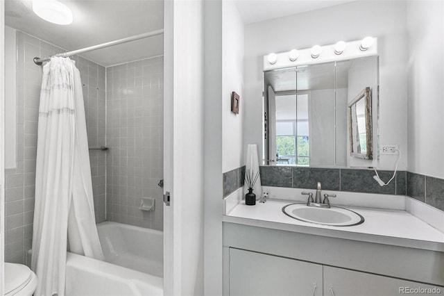 full bathroom with vanity, shower / bath combination with curtain, and toilet