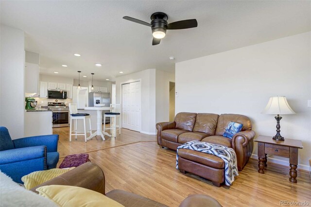 1944 Queens Canyon Ct, Colorado Springs, CO 80921 - living room featuring baseboards, light wood-type flooring, ceiling fan, and recessed lighting