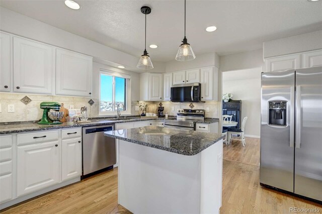 1944 Queens Canyon Ct, Colorado Springs, CO 80921 - kitchen featuring a sink, white cabinets, a center island, and stainless steel appliances