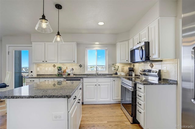 1944 Queens Canyon Ct, Colorado Springs, CO 80921 - kitchen featuring white cabinets, light wood-style flooring, a sink, and appliances with stainless steel finishes