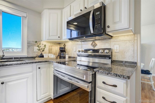 1944 Queens Canyon Ct, Colorado Springs, CO 80921 - kitchen featuring a sink, white cabinetry, wood finished floors, and stainless steel appliances