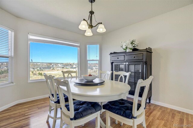 1944 Queens Canyon Ct, Colorado Springs, CO 80921 - dining area featuring light wood-style flooring, plenty of natural light, a chandelier, and baseboards