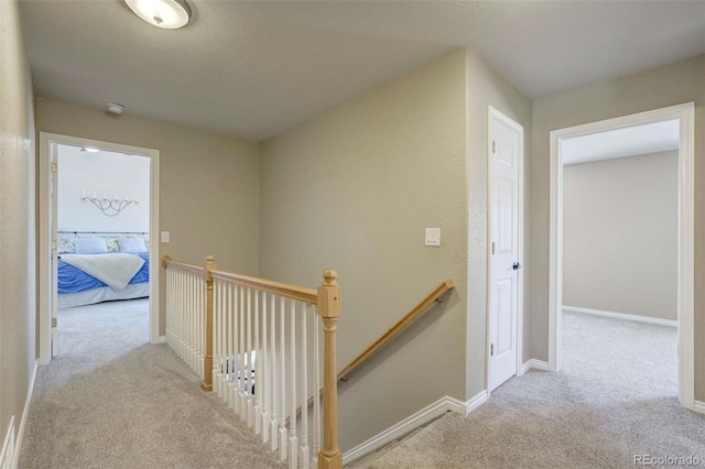1944 Queens Canyon Ct, Colorado Springs, CO 80921 - hallway featuring baseboards, an upstairs landing, and carpet flooring