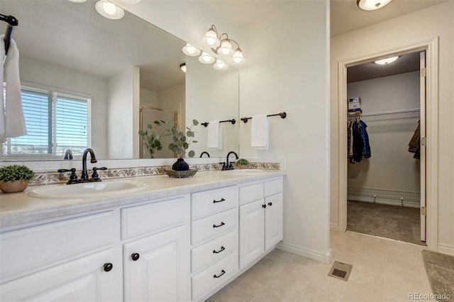 1944 Queens Canyon Ct, Colorado Springs, CO 80921 - full bath with a stall shower, double vanity, a sink, and a walk in closet