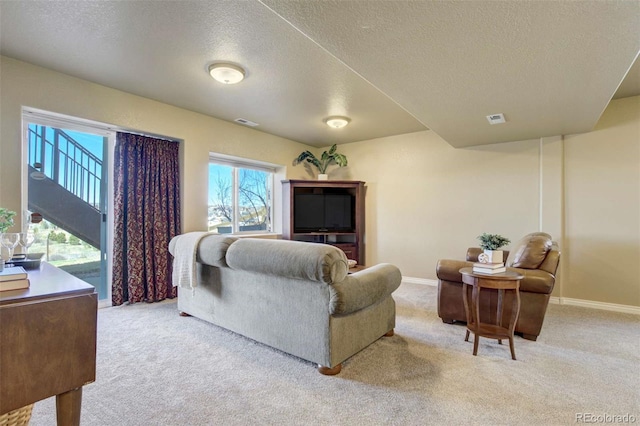 1944 Queens Canyon Ct, Colorado Springs, CO 80921 - living area featuring visible vents, carpet floors, and a textured ceiling
