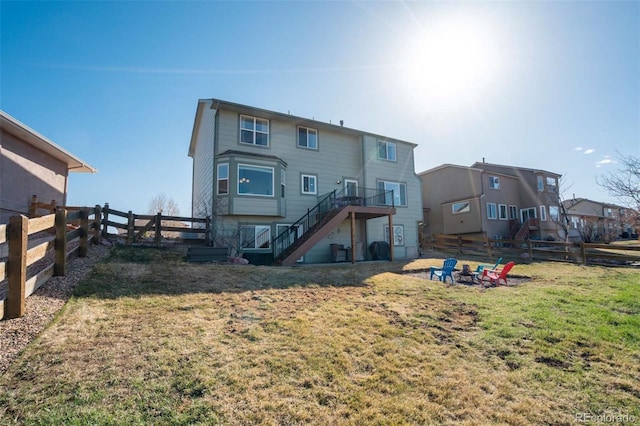 1944 Queens Canyon Ct, Colorado Springs, CO 80921 - rear view of house with fence, a lawn, and stairs