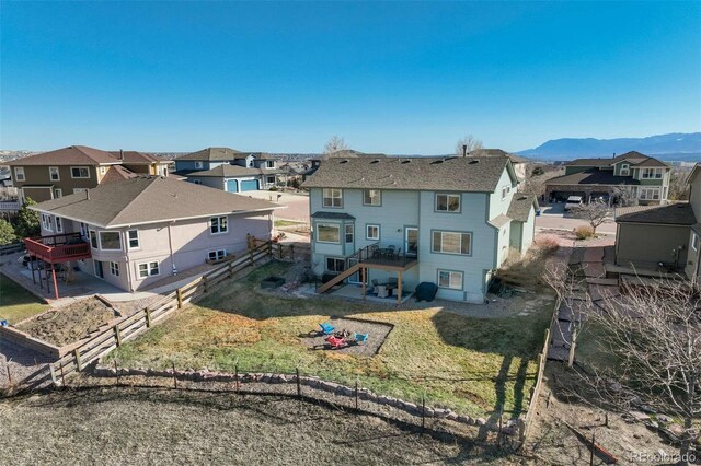 1944 Queens Canyon Ct, Colorado Springs, CO 80921 - back of house with a residential view, a fenced backyard, a mountain view, and a yard