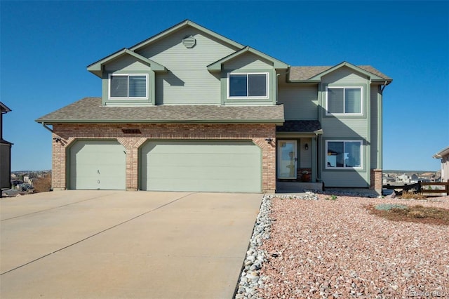 1944 Queens Canyon Ct, Colorado Springs, CO 80921 - view of front of house featuring a shingled roof, brick siding, driveway, and an attached garage