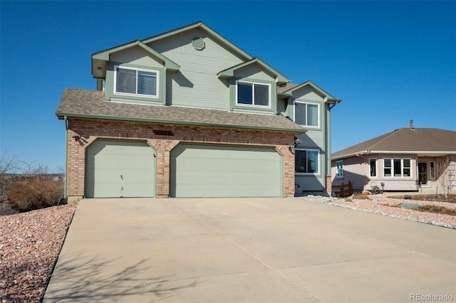 1944 Queens Canyon Ct, Colorado Springs, CO 80921 - view of front of home featuring a shingled roof, brick siding, driveway, and an attached garage