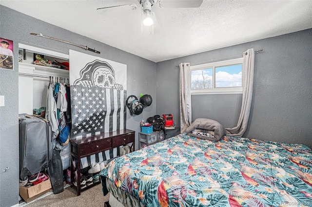 bedroom featuring carpet flooring, a ceiling fan, a textured wall, and a textured ceiling