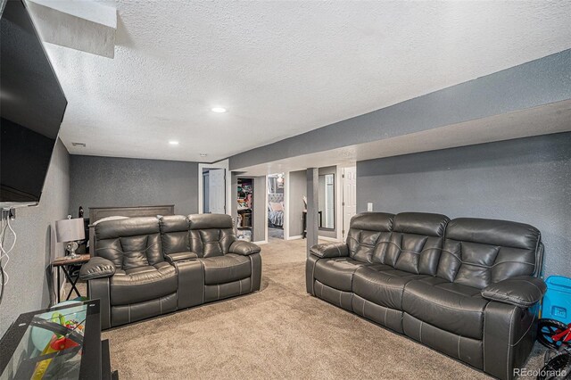 carpeted cinema room featuring recessed lighting, a textured ceiling, and a textured wall