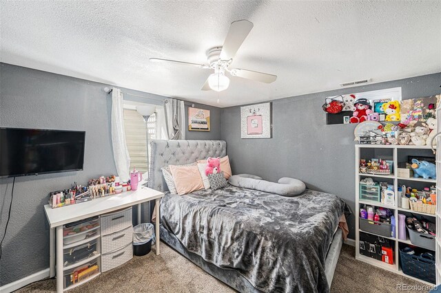 bedroom featuring visible vents, ceiling fan, carpet, a textured wall, and a textured ceiling