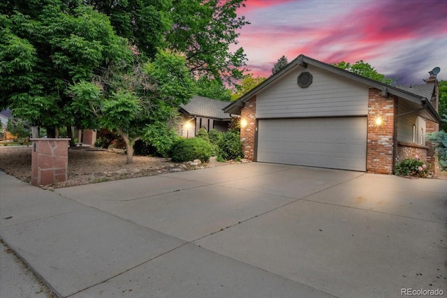 1665 W 113th Ave, Denver, CO 80234 - view of front of house featuring brick siding, an attached garage, and concrete driveway