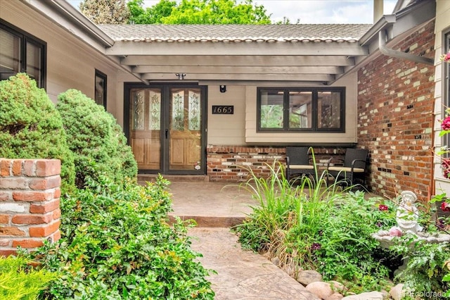 1665 W 113th Ave, Denver, CO 80234 - view of exterior entry with covered porch and brick siding