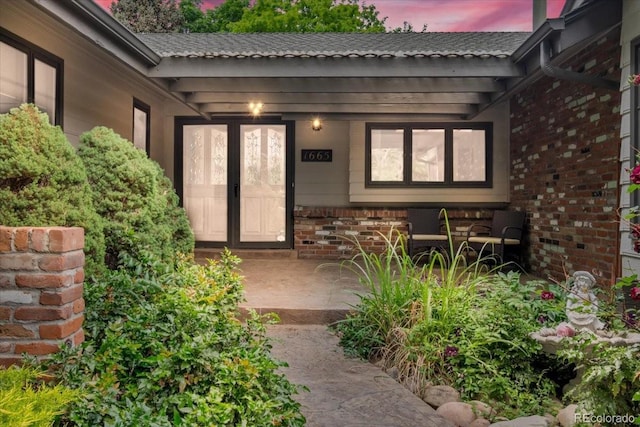 1665 W 113th Ave, Denver, CO 80234 - view of exterior entry with a porch and brick siding