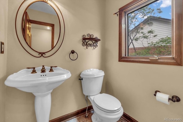 1665 W 113th Ave, Denver, CO 80234 - bathroom featuring baseboards, toilet, and a sink