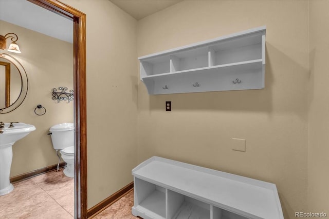 1665 W 113th Ave, Denver, CO 80234 - mudroom featuring baseboards, light tile patterned floors, and a sink