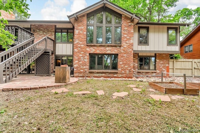 1665 W 113th Ave, Denver, CO 80234 - back of house with a vegetable garden, a patio, brick siding, and stairway