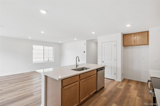 kitchen with a sink, light countertops, stainless steel dishwasher, light wood-type flooring, and brown cabinetry