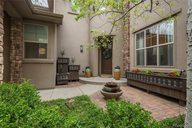 9266 E 35th Ave, Denver, CO 80238 - doorway to property with stucco siding and a patio area