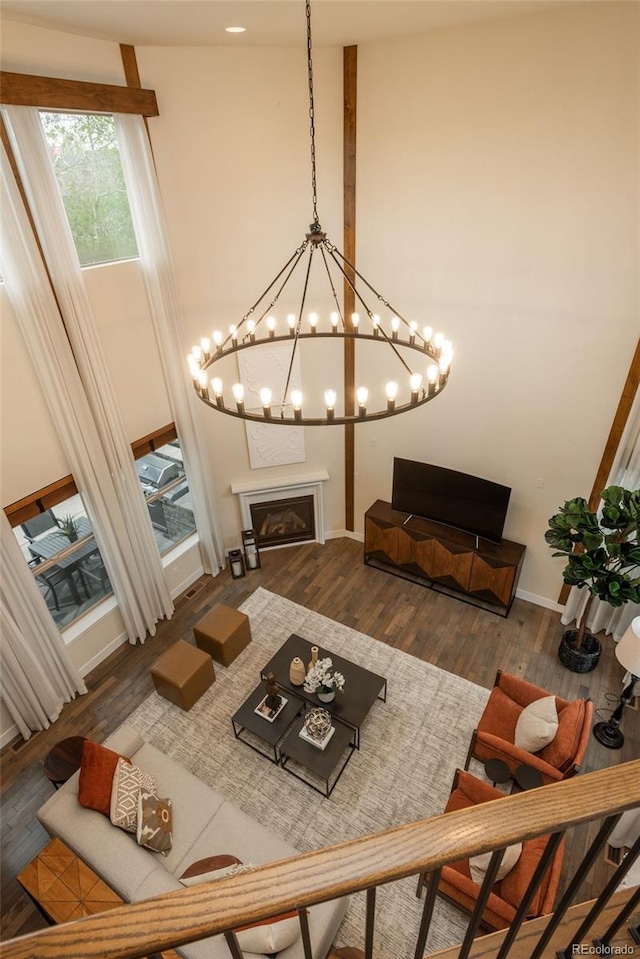 9266 E 35th Ave, Denver, CO 80238 - living room with a fireplace, wood finished floors, baseboards, and a chandelier