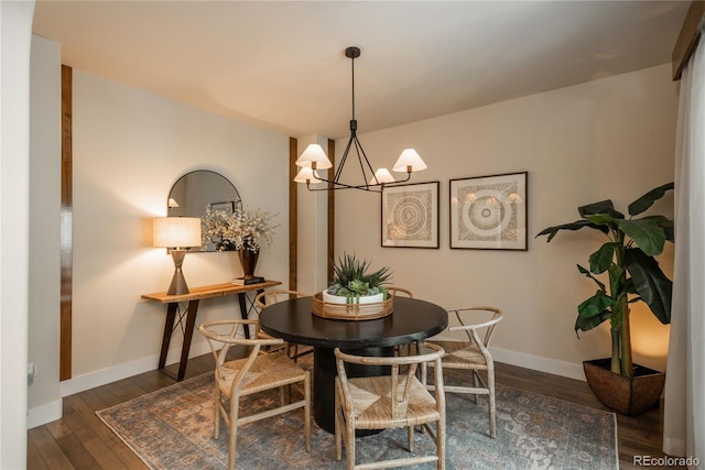 9266 E 35th Ave, Denver, CO 80238 - dining room featuring a chandelier, wood finished floors, and baseboards