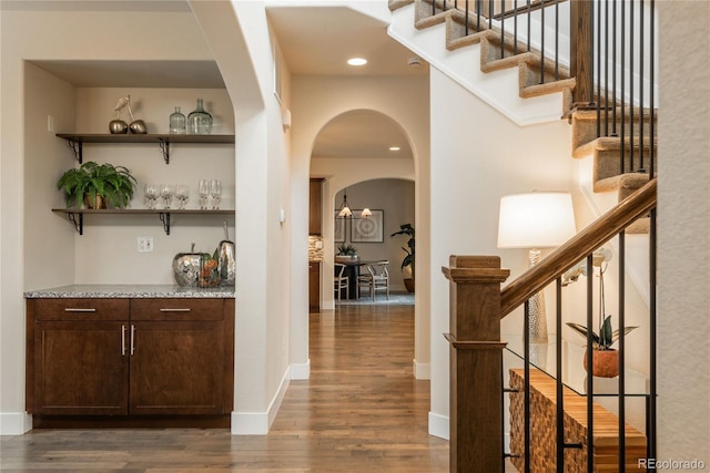 9266 E 35th Ave, Denver, CO 80238 - indoor dry bar featuring stairway, dark wood-style flooring, arched walkways, recessed lighting, and baseboards