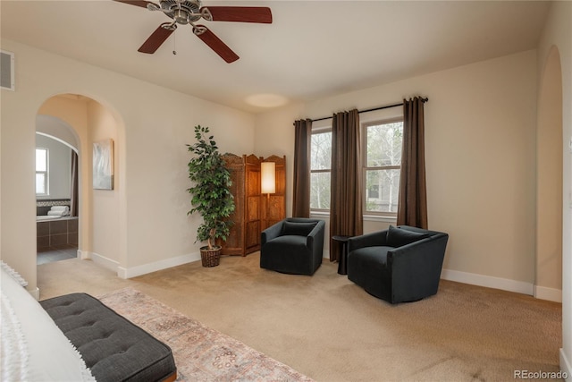 9266 E 35th Ave, Denver, CO 80238 - sitting room featuring carpet floors, arched walkways, a ceiling fan, and baseboards