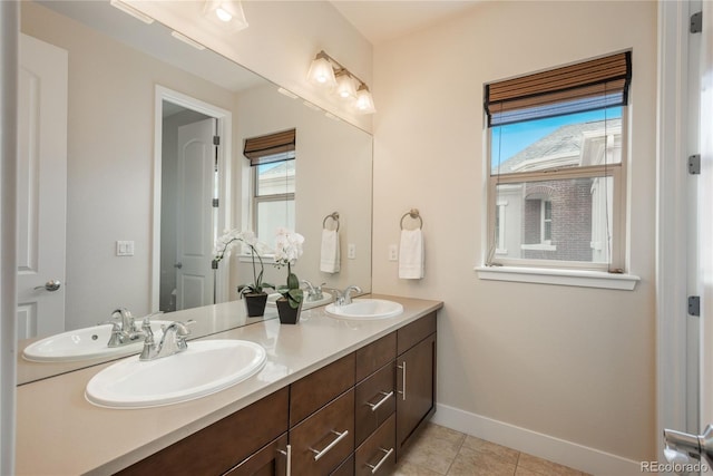 9266 E 35th Ave, Denver, CO 80238 - bathroom featuring double vanity, baseboards, and tile patterned flooring