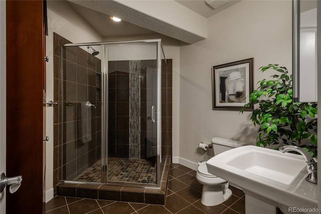 9266 E 35th Ave, Denver, CO 80238 - full bath featuring toilet, a stall shower, baseboards, tile patterned floors, and a sink