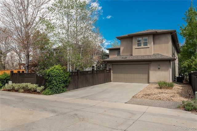 9266 E 35th Ave, Denver, CO 80238 - view of front of house with stucco siding, an attached garage, central air condition unit, and concrete driveway