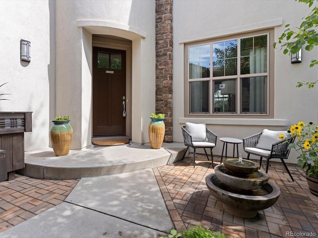 9266 E 35th Ave, Denver, CO 80238 - doorway to property with stucco siding, a patio, and stone siding